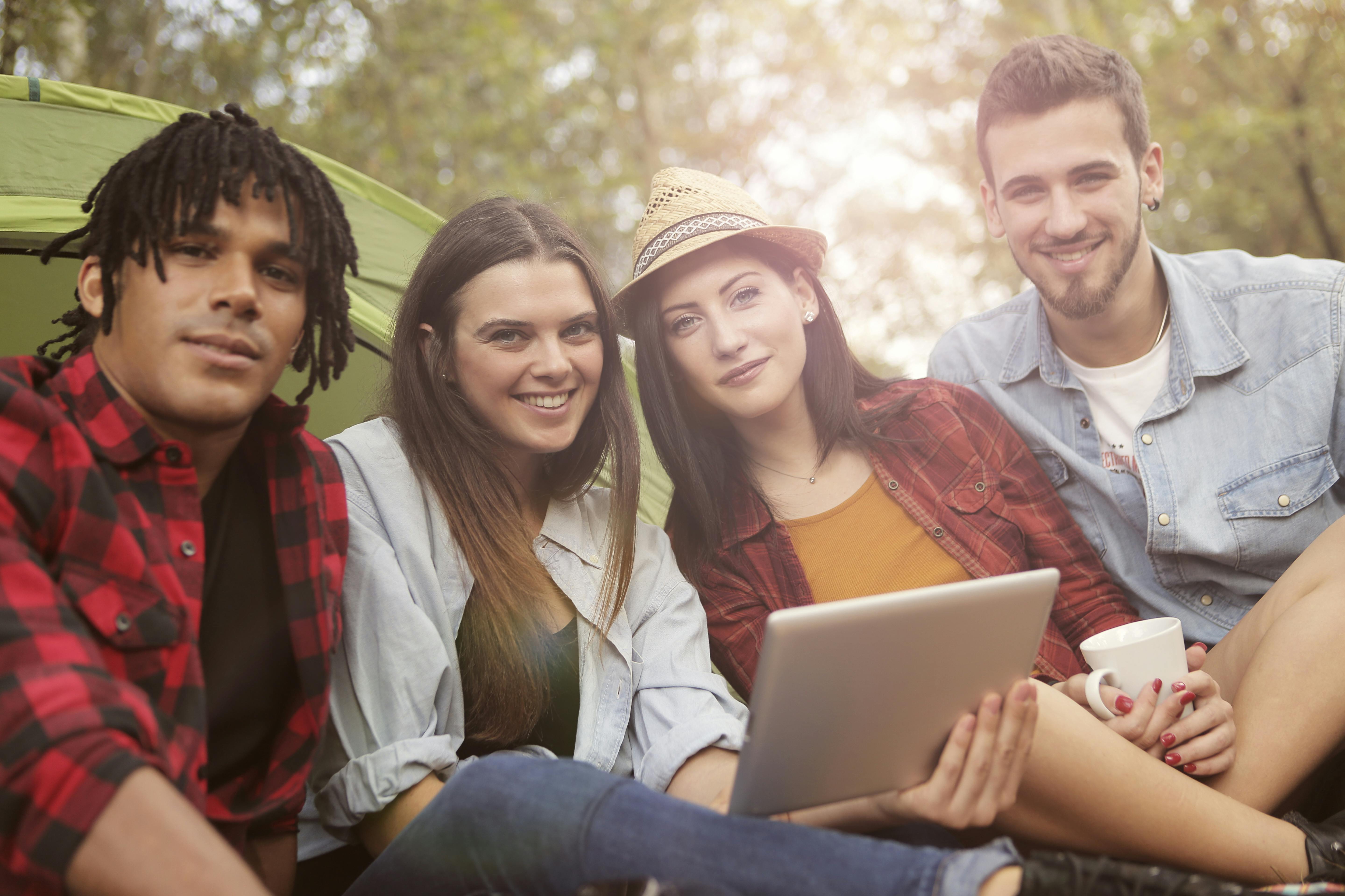 4 people camping with mobile phones