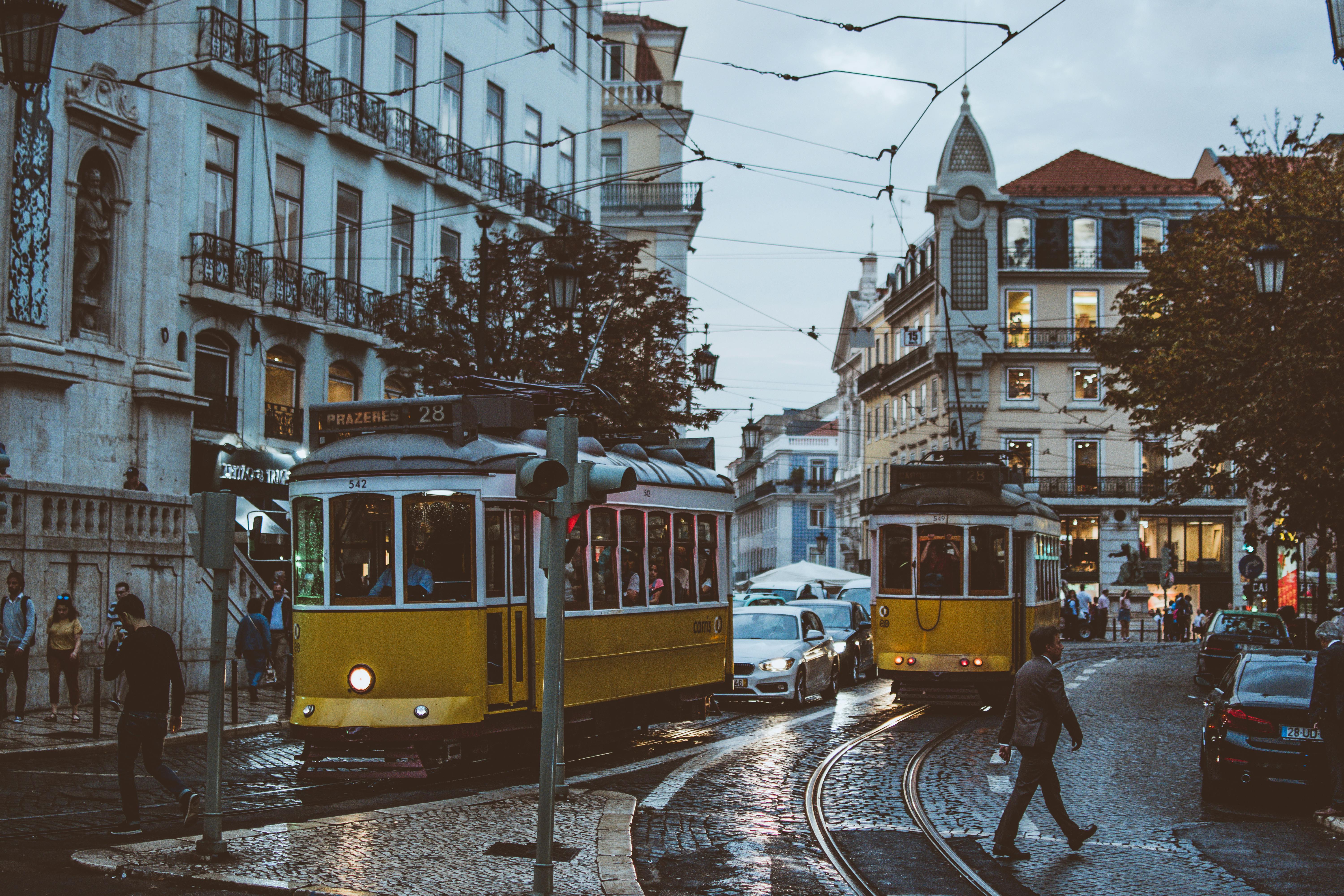 yellow public street car in city setting